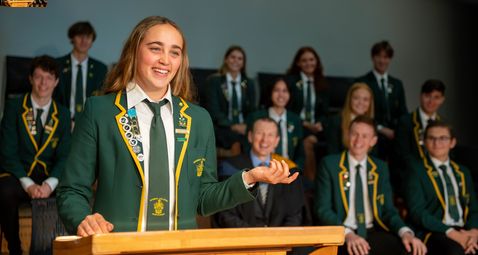Growing Future Leaders Mobile Head student addressing school assembly