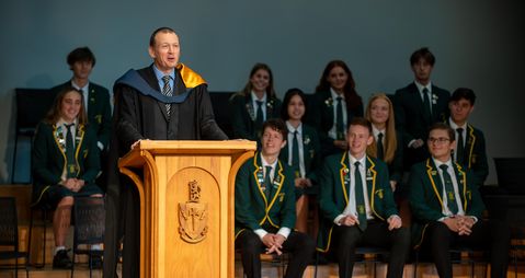 Principal addressing school assembly