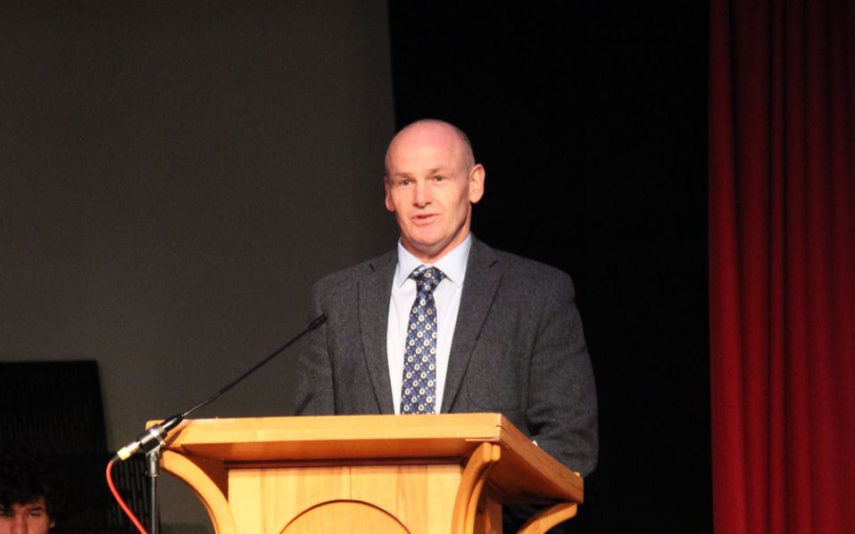 Principal addressing school assembly